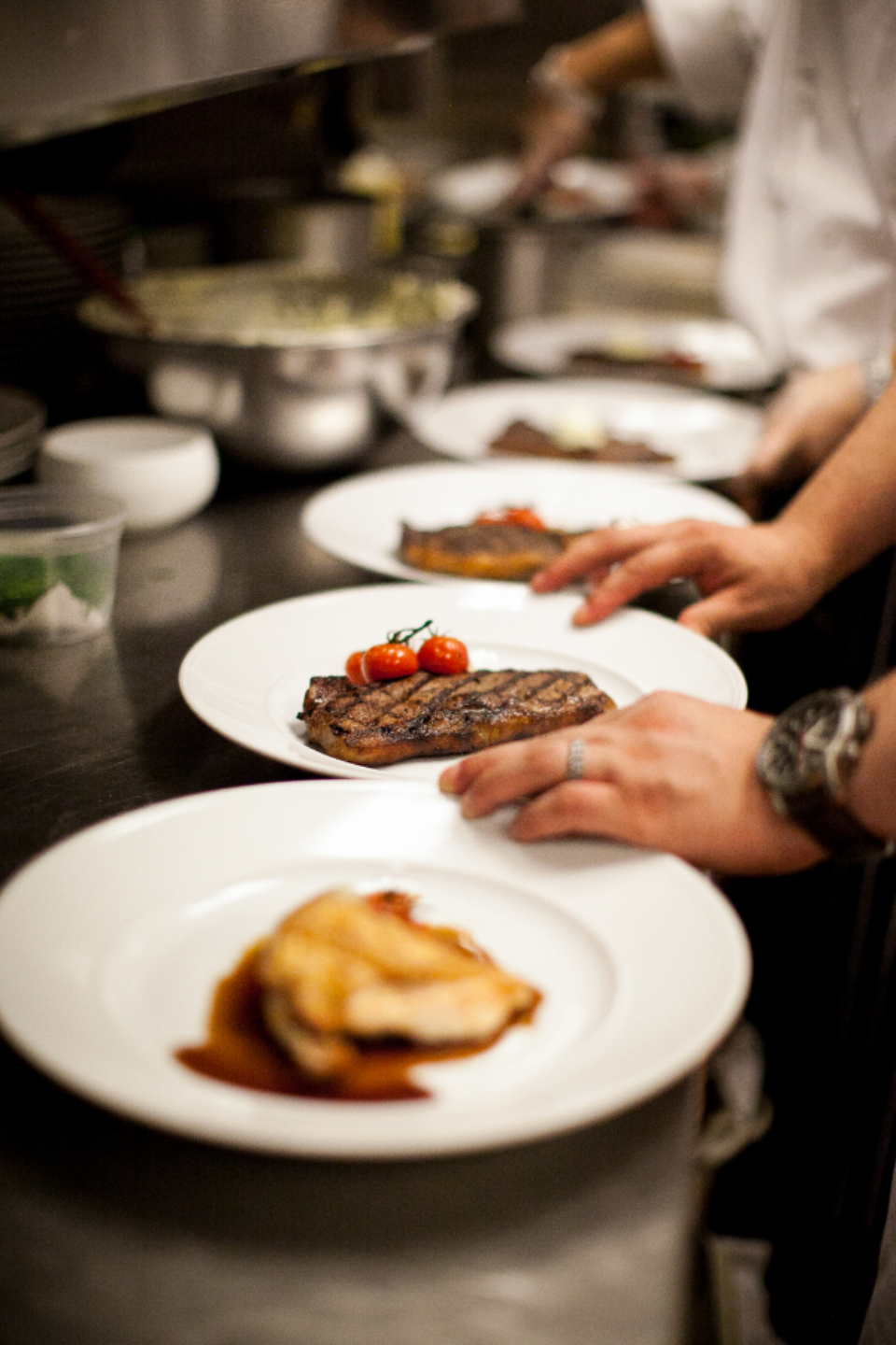 Chef plating canapés in the kitchen