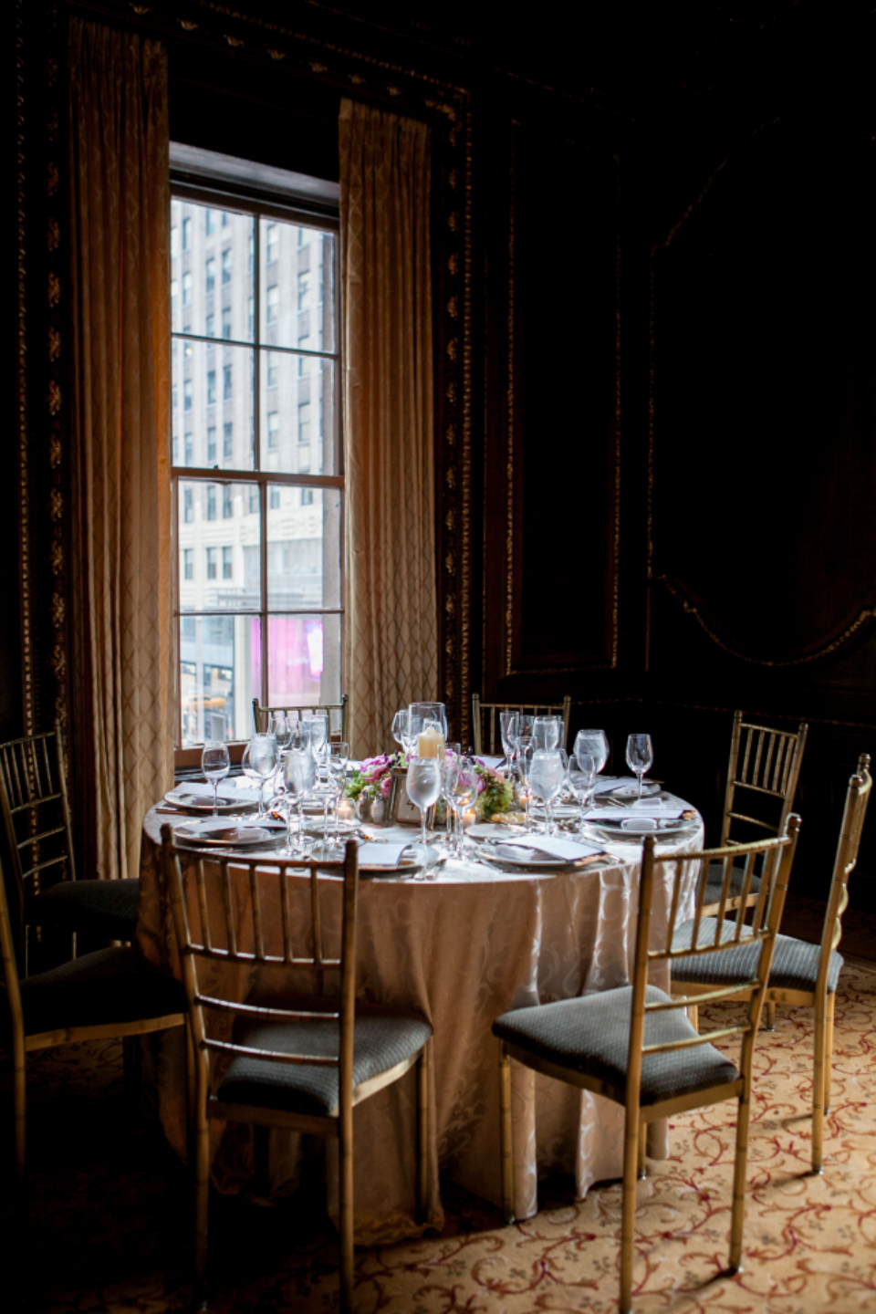 Round banquet tables laid in a hotel function suite